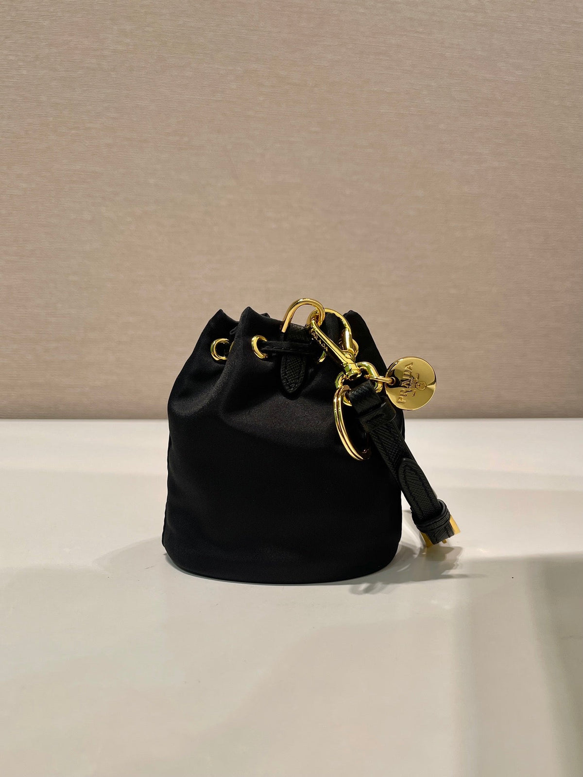 PRADA MINI BUCKET BAG 10 IN BLACK RE-NYLON AND SAFFIANO LEATHER STRAP